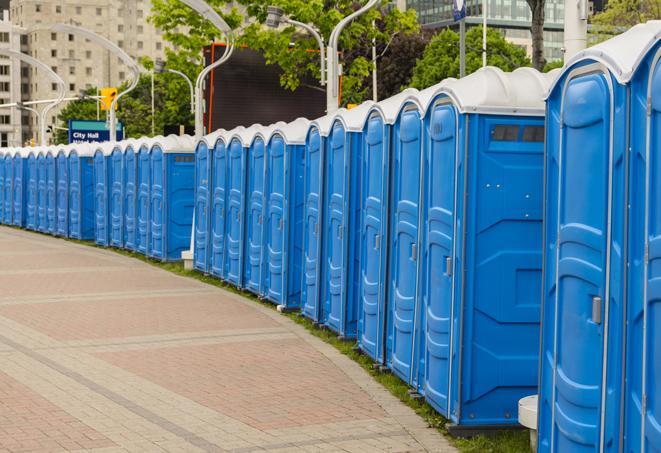 a line of portable restrooms set up for a wedding or special event, ensuring guests have access to comfortable and clean facilities throughout the duration of the celebration in Brookville